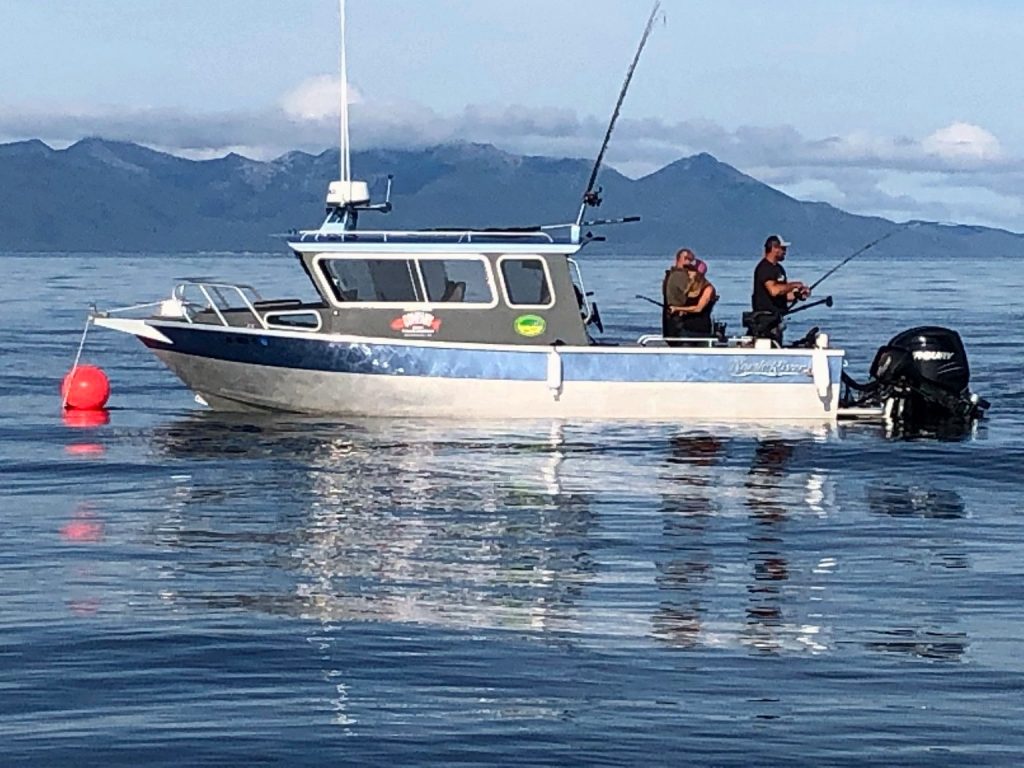Side view of the boat with anglers fishing