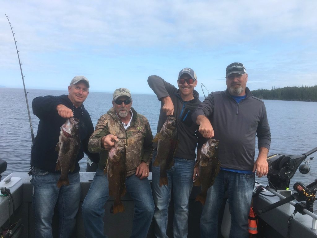 Group of guests showing off their catch after a charter