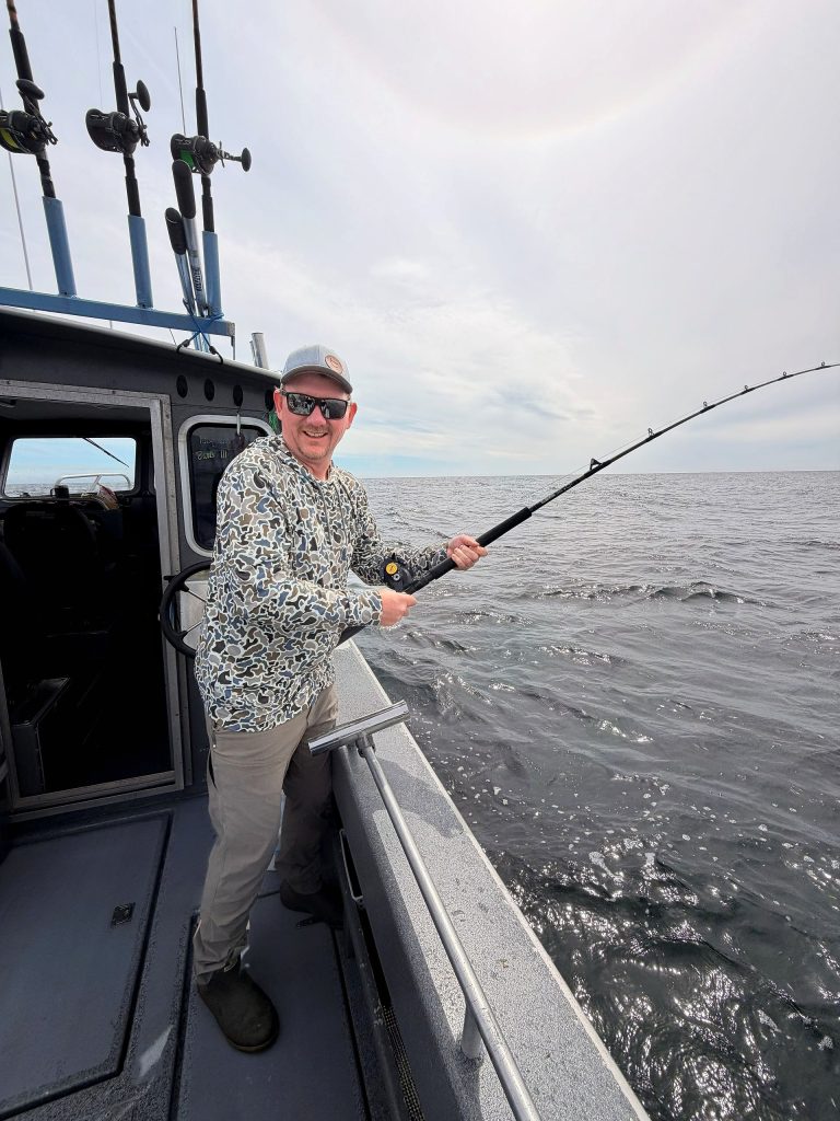 Angler fighting a fish with the rod bent on a Ketchikan charter