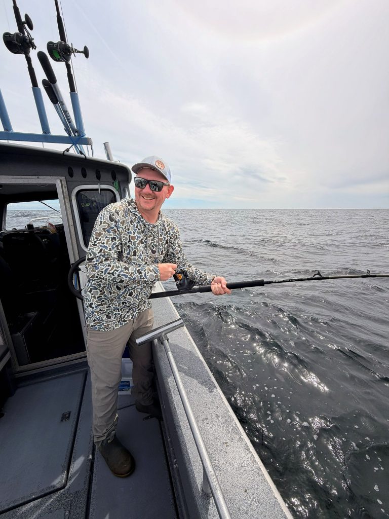 Rod bent into a fish aboard an Alaska Fishing Company charter