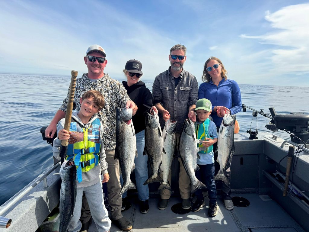 A family of five with their salmon catch aboard the charter