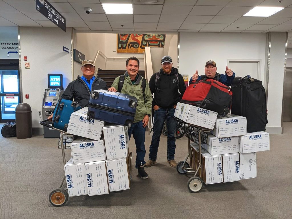 Guests with boxed, processed fish ready for the flight home