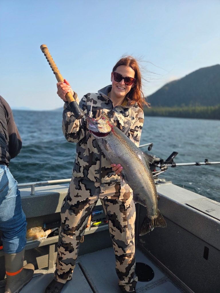 Guest holding a bright salmon