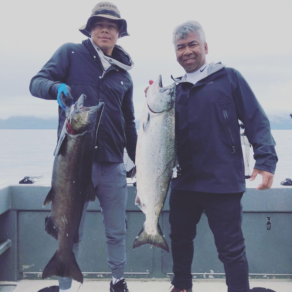 Two anglers holding salmon caught on a Ketchikan charter